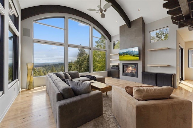 2503 S Thierman Ln, Spokane, WA 99223 - living area with built in shelves, a fireplace, wood finished floors, plenty of natural light, and high vaulted ceiling