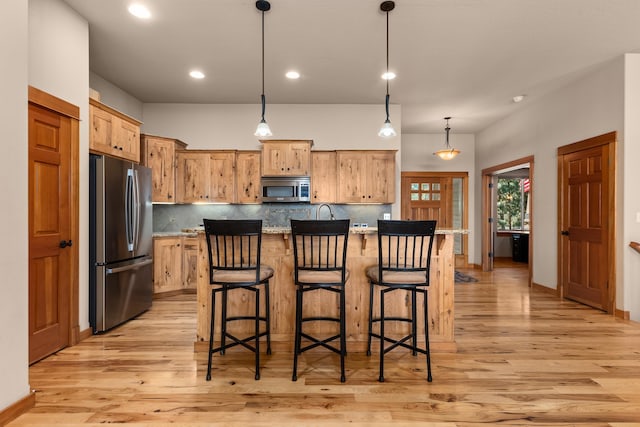 9510 N Doak Rd, Spokane, WA 99217 - kitchen featuring appliances with stainless steel finishes, light wood-style floors, backsplash, and recessed lighting