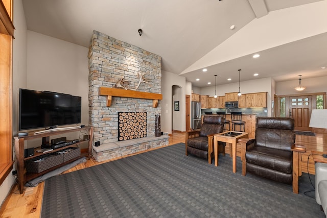 9510 N Doak Rd, Spokane, WA 99217 - living room featuring a stone fireplace, recessed lighting, light wood-style floors, high vaulted ceiling, and beam ceiling