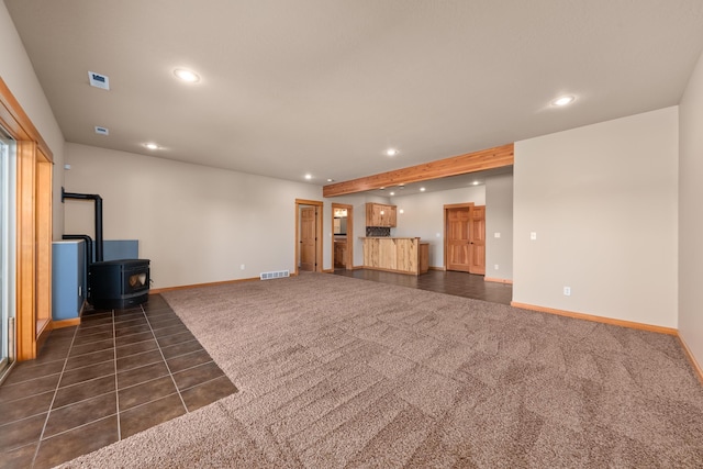 9510 N Doak Rd, Spokane, WA 99217 - unfurnished living room with recessed lighting, a wood stove, and dark colored carpet