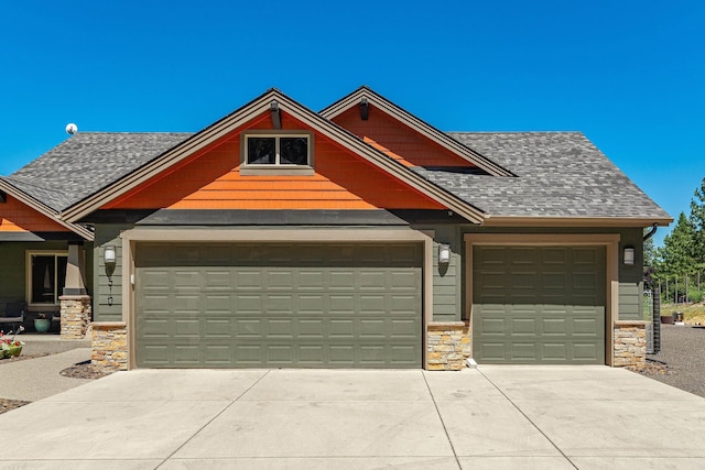 9510 N Doak Rd, Spokane, WA 99217 - view of front of house with stone siding, driveway, an attached garage, and a shingled roof