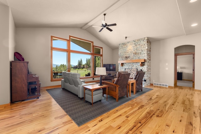 9510 N Doak Rd, Spokane, WA 99217 - living room with a stone fireplace, a ceiling fan, wood finished floors, arched walkways, and recessed lighting