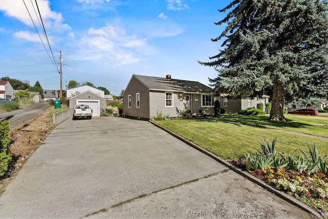 4910 N A St, Spokane, WA 99205 - view of front facade with driveway, a detached garage, a front yard, and an outbuilding