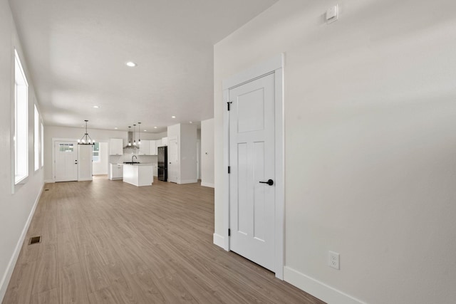 L4 E Sharp Ln, Spokane Valley, WA 99206 - unfurnished living room featuring light wood-style flooring and recessed lighting