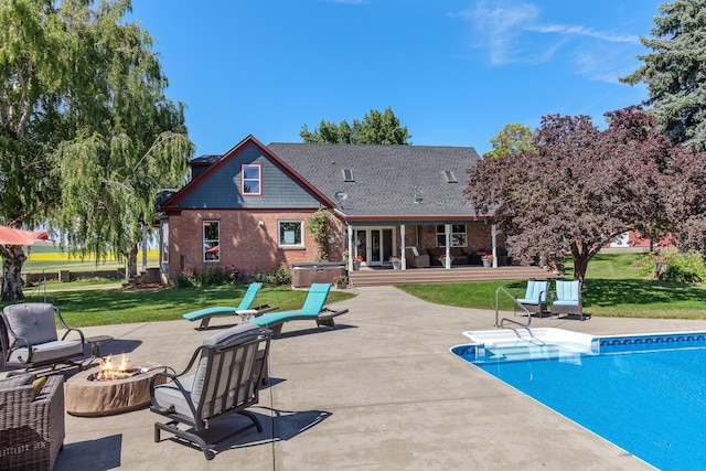 28752 Tramm Rd, Reardan, WA 99029 - swimming pool featuring a hot tub, a patio area, a yard, and an outdoor living space with a fire pit