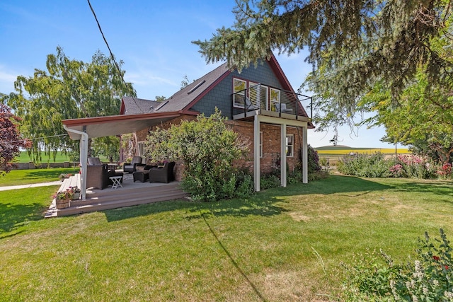 28752 Tramm Rd, Reardan, WA 99029 - back of house featuring an outdoor hangout area, a lawn, a balcony, and brick siding