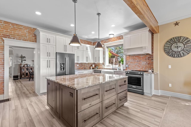 28752 Tramm Rd, Reardan, WA 99029 - kitchen featuring stainless steel appliances, white cabinetry, light wood finished floors, ornamental molding, and recessed lighting