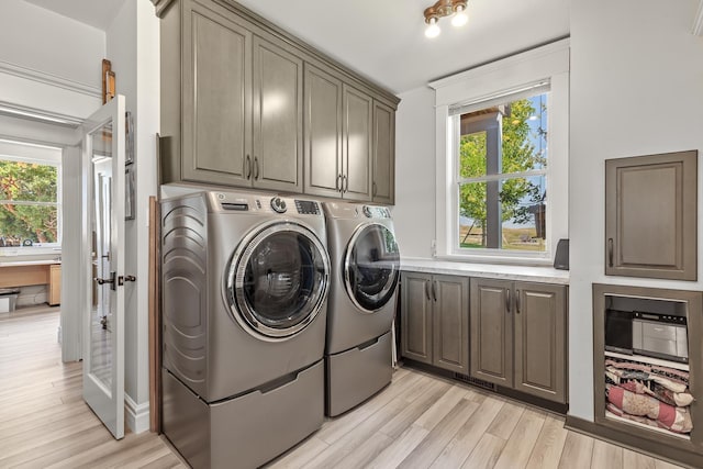 28752 Tramm Rd, Reardan, WA 99029 - washroom featuring cabinet space, washer and dryer, and light wood-type flooring