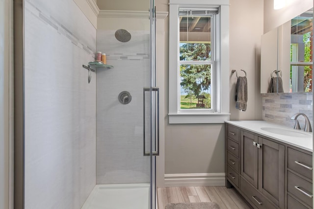 28752 Tramm Rd, Reardan, WA 99029 - bathroom featuring a shower stall, vanity, wood finished floors, and ornamental molding