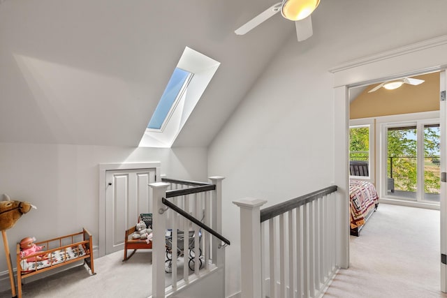 28752 Tramm Rd, Reardan, WA 99029 - stairway featuring lofted ceiling, carpet floors, a ceiling fan, and a skylight