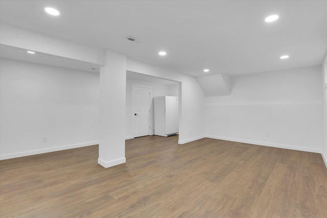 10946 W Sagewood Rd, Nine Mile Falls, WA 99026 - finished basement featuring recessed lighting, wood finished floors, and freestanding refrigerator