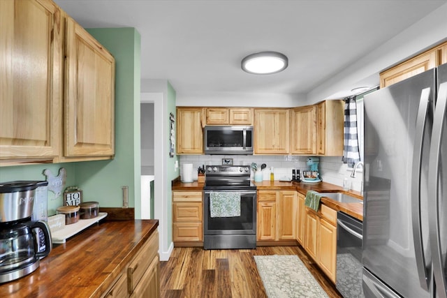 10946 W Sagewood Rd, Nine Mile Falls, WA 99026 - kitchen with appliances with stainless steel finishes, wooden counters, dark wood-style floors, light brown cabinets, and backsplash