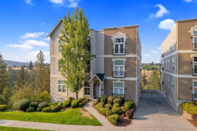 2230 W Riverside Ave # 302, Spokane, WA 99201 - view of front facade featuring stucco siding and french doors