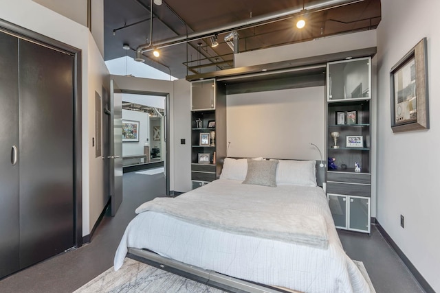2230 W Riverside Ave # 302, Spokane, WA 99201 - bedroom with baseboards and rail lighting