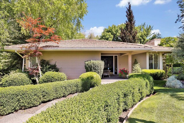 4402 S Saint Andrews Ln, Spokane, WA 99223 - ranch-style house featuring a chimney, a patio area, and a front lawn