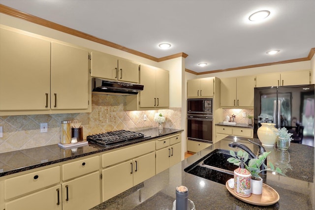 4402 S Saint Andrews Ln, Spokane, WA 99223 - kitchen featuring black appliances, under cabinet range hood, cream cabinets, crown molding, and tasteful backsplash