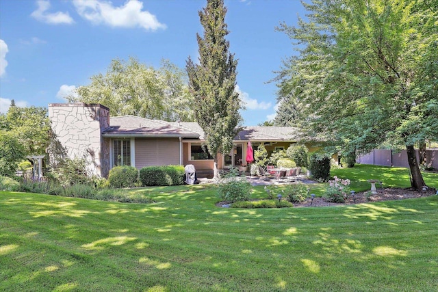 4402 S Saint Andrews Ln, Spokane, WA 99223 - back of house featuring a patio and a chimney