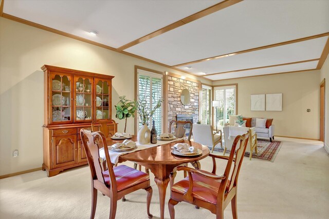 4402 S Saint Andrews Ln, Spokane, WA 99223 - dining area featuring light carpet, plenty of natural light, a stone fireplace, and ornamental molding
