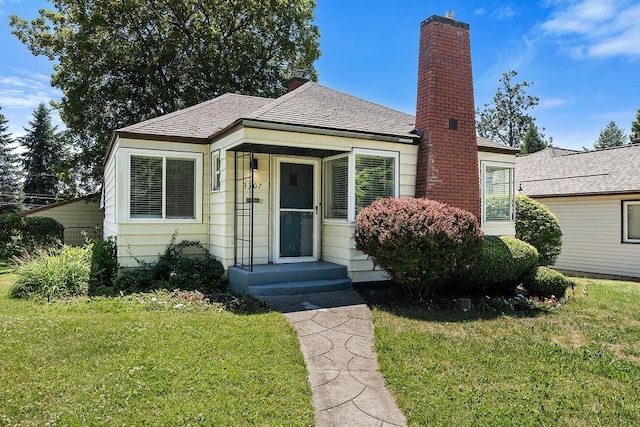 3307 W Euclid Ave, Spokane, WA 99205 - view of front facade with a front lawn, a chimney, and a shingled roof