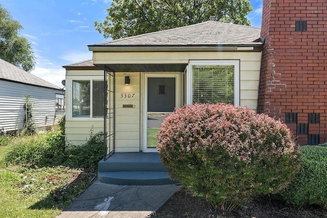 3307 W Euclid Ave, Spokane, WA 99205 - doorway to property featuring roof with shingles