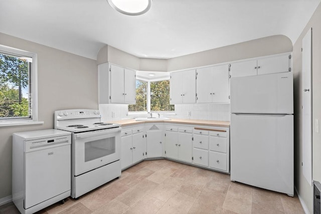 3307 W Euclid Ave, Spokane, WA 99205 - kitchen with white appliances, plenty of natural light, and light countertops