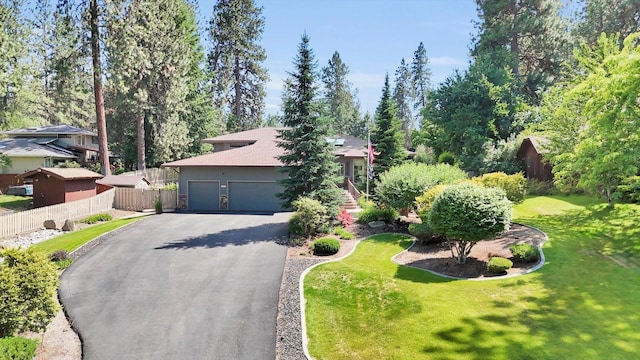 10612 E 46th Ave, Spokane Valley, WA 99206 - view of property hidden behind natural elements with driveway, an attached garage, and view of scattered trees