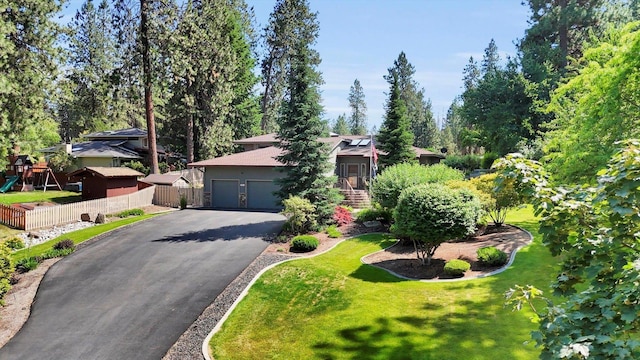 10612 E 46th Ave, Spokane Valley, WA 99206 - obstructed view of property with driveway, a garage, and view of scattered trees