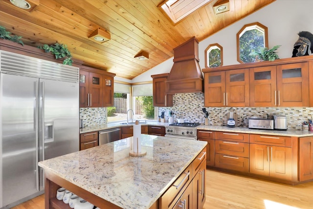 10612 E 46th Ave, Spokane Valley, WA 99206 - kitchen featuring high end appliances, custom exhaust hood, vaulted ceiling, a skylight, and wood ceiling