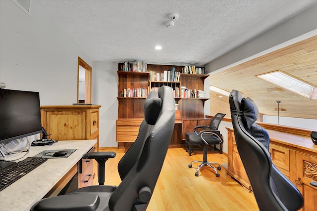 10612 E 46th Ave, Spokane Valley, WA 99206 - office featuring light wood-style floors, a textured ceiling, a skylight, and recessed lighting