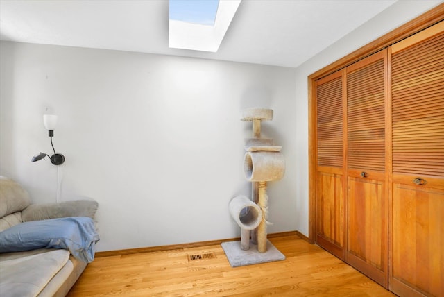 10612 E 46th Ave, Spokane Valley, WA 99206 - bedroom featuring a skylight, a closet, and light wood-style flooring