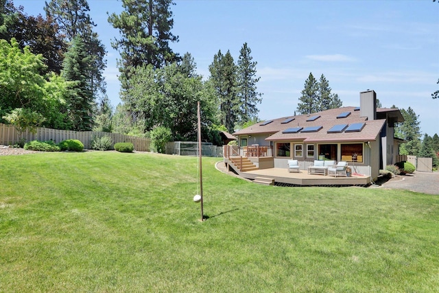10612 E 46th Ave, Spokane Valley, WA 99206 - fenced backyard featuring outdoor lounge area, a deck, and an area to practice putting