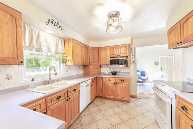 1018 N Fox Rd, Spokane Valley, WA 99206 - kitchen featuring white appliances, backsplash, light countertops, and light tile patterned floors