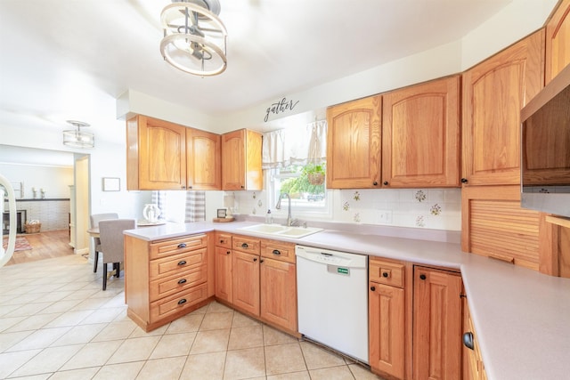 1018 N Fox Rd, Spokane Valley, WA 99206 - kitchen with dishwasher, light countertops, light tile patterned flooring, and a peninsula