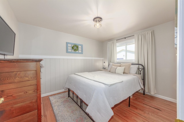 1018 N Fox Rd, Spokane Valley, WA 99206 - bedroom with light wood-style floors and wainscoting