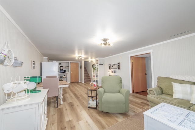 1018 N Fox Rd, Spokane Valley, WA 99206 - living room featuring ornamental molding, light wood-style flooring, and stairs