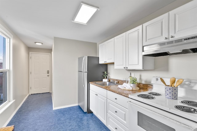 1023 W Maxwell Ave, Spokane, WA 99201 - kitchen with white range with electric stovetop, under cabinet range hood, carpet, and white cabinetry