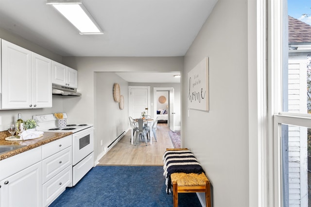 1023 W Maxwell Ave, Spokane, WA 99201 - kitchen with white range with electric cooktop, under cabinet range hood, white cabinets, baseboard heating, and light wood finished floors