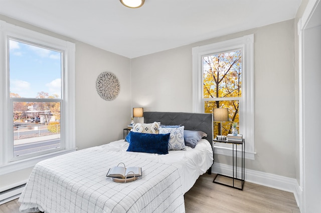 1023 W Maxwell Ave, Spokane, WA 99201 - bedroom featuring baseboard heating and wood finished floors