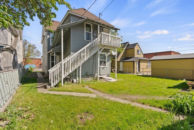 1023 W Maxwell Ave, Spokane, WA 99201 - back of property with stairs, a fenced backyard, and roof with shingles