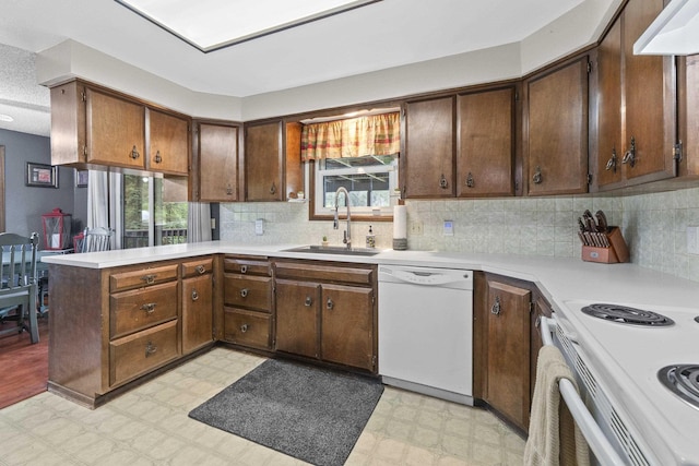 15906 N Forker Rd, Spokane, WA 99217 - kitchen with white appliances, light floors, healthy amount of natural light, and light countertops