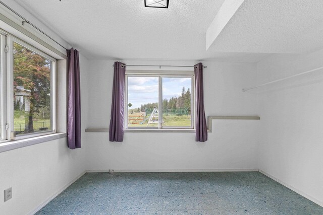 15906 N Forker Rd, Spokane, WA 99217 - spare room featuring a textured ceiling and baseboards