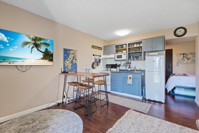 28600 N Mt Spokane Park Dr Unit 612, Mead, WA 99021 - kitchen featuring white appliances, dark wood finished floors, open shelves, a textured ceiling, and blue cabinets