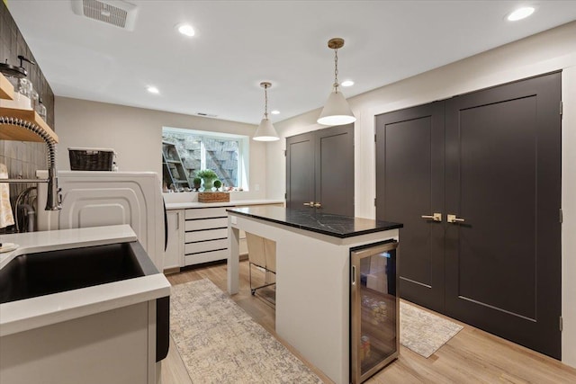 4108 S Greystone Ln, Spokane, WA 99223 - kitchen with beverage cooler, light wood-type flooring, pendant lighting, a center island, and recessed lighting
