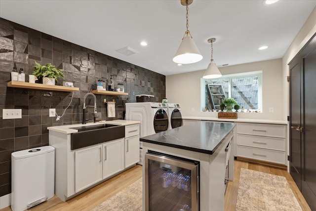 4108 S Greystone Ln, Spokane, WA 99223 - kitchen with beverage cooler, washer and clothes dryer, light wood-style floors, open shelves, and recessed lighting
