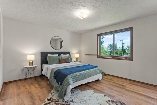 3827 E Funk Ave, Spokane, WA 99223 - bedroom with wood finished floors and a textured ceiling