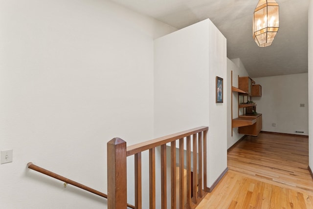 3827 E Funk Ave, Spokane, WA 99223 - hallway featuring an upstairs landing, wood finished floors, a chandelier, and lofted ceiling