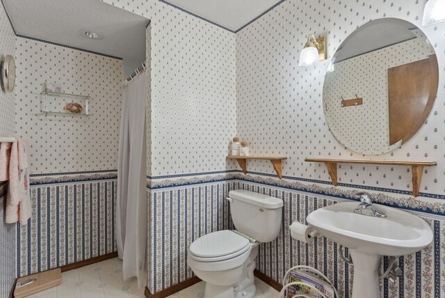 3827 E Funk Ave, Spokane, WA 99223 - bathroom with wallpapered walls and a shower with shower curtain
