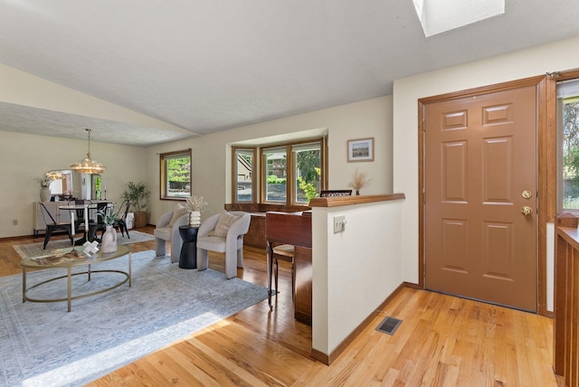 3827 E Funk Ave, Spokane, WA 99223 - foyer entrance with light wood-style floors, vaulted ceiling, and a chandelier