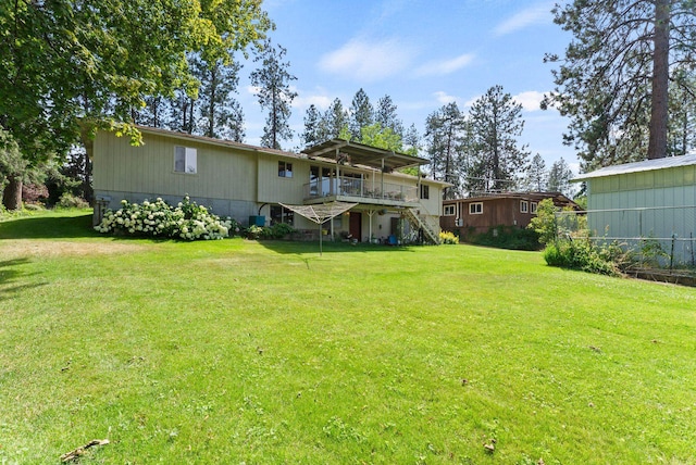 3827 E Funk Ave, Spokane, WA 99223 - rear view of house featuring stairs, a wooden deck, and a yard
