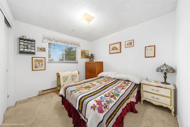 4511 N Stevenson Rd, Otis Orchards, WA 99027 - carpeted bedroom featuring a baseboard radiator, a closet, and a textured ceiling